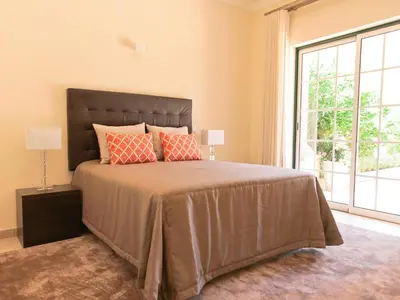 a bedroom with a large bed with a large window at Exceptional villa with swimming pool in Almancil