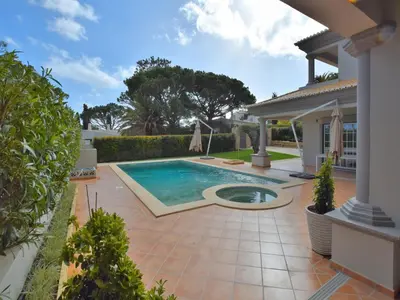 a swimming pool in the backyard of a house at Exceptional villa with swimming pool in Almancil