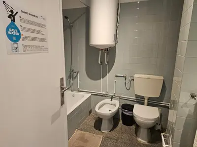 a bathroom with a toilet and a sink and a bath tub at Blife Spanya - private rooms at Santantonya 3rd floor in Faro