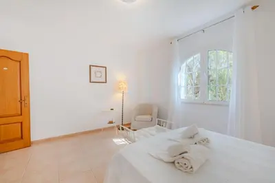 a white bedroom with a bed with towels on it at Villa Monte da Torre in Loulé