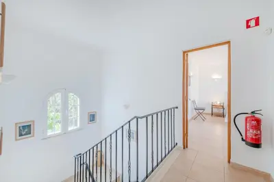 a staircase with a fire extinguisher in a house at Villa Monte da Torre in Loulé
