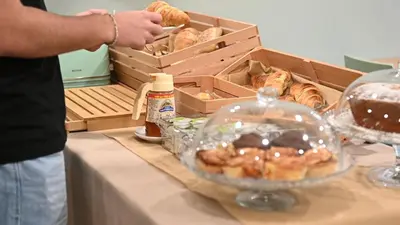 a person standing next to a table with a box of pastries at Quinta do Moinho in Loulé