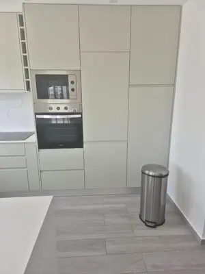 a kitchen with a stove and a trash can at Beautiful View Apartment in Quarteira