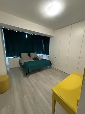 a bedroom with a bed with a green blanket at Beautiful View Apartment in Quarteira