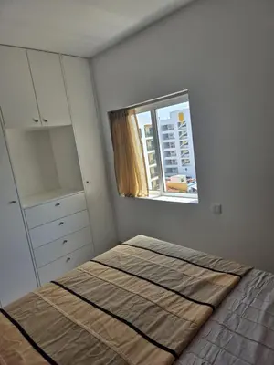 a small bedroom with a bed and a window at Beautiful View Apartment in Quarteira