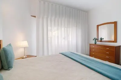 a living room with a couch and a table at Apartamento da Praia in Quarteira