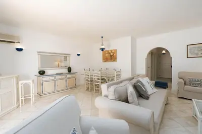 a living room with a couch and a table at Serenity Villa Vilamoura in Quarteira