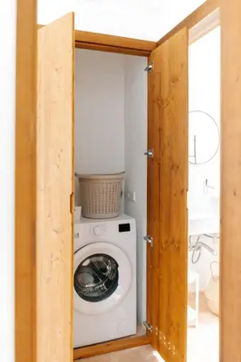 a laundry room with a washer and dryer in a bathroom at Casa Majú - Algarve in Valados