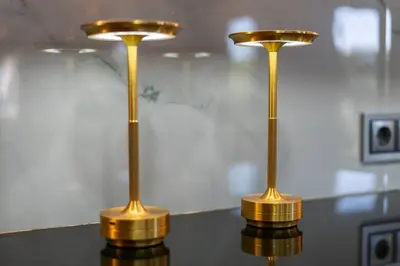 two gold lights sitting on top of a table at Stylish Algarve Retreat- Priv. Pool & Beach Nearby in Quarteira