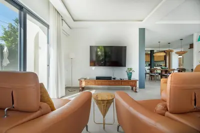 a living room with two couches and a tv at Stylish Algarve Retreat- Priv. Pool & Beach Nearby in Quarteira