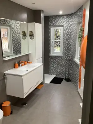a bathroom with a white sink and a window at Villa Karolina in Quarteira