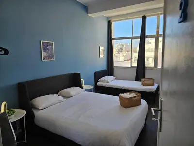 a small room with two beds and a window at Blife Europya - private rooms at Santantonya 3rd floor in Faro