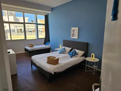 a bedroom with a bed with a blue wall at Blife Europya - private rooms at Santantonya 3rd floor in Faro