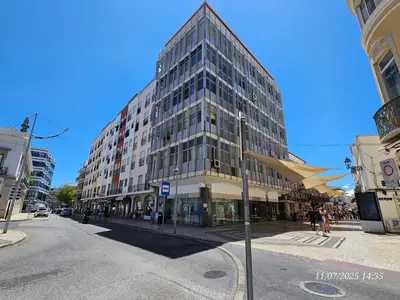 a tall glass building on a city street at Blife Europya - private rooms at Santantonya 3rd floor in Faro