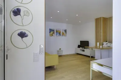 a living room with a table and a room with a door at GINGKO BILOBA ROOF TOP by My Algarve Rentals in Quarteira