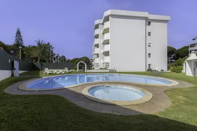 a swimming pool in front of a building at GINGKO BILOBA ROOF TOP by My Algarve Rentals in Quarteira