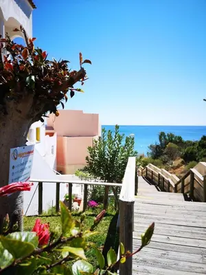 a bedroom with two beds and a large window at Casa João Bravo in Albufeira