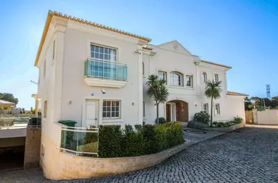 a large white house with a stone driveway at Luxury Villa with Private Pool, Gym & Leisure Room by Gale Beach LM25 in Guia