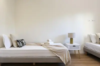a white bedroom with a bed and a couch at Mira Mar 1 - Near the beach by HD in Quarteira