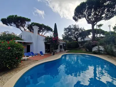 a swimming pool on the roof of a house at Vintage design villa in Vale do Lobo in Loulé