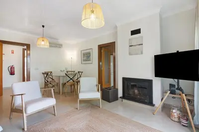 a living room with a tv and a fireplace at Do Vale Hollidays in Guia