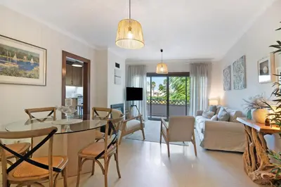 a dining room and living room with a table and chairs at Do Vale Hollidays in Guia