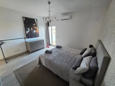 a bedroom with a bed and a couch at Casa Madalena in Albufeira