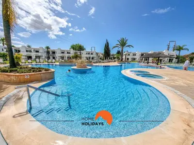a swimming pool at a resort with buildings in the background at #121 T1 Aconchegante em Albufeira by Home Holidays in Albufeira