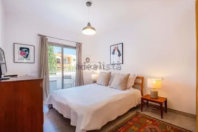 a bedroom with a bed and a desk and a window at Galé by the Sea in Guia