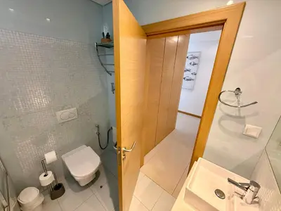 a bathroom with a toilet and a sink and a shower at Apartamento Flor de Amendoeira Garden in Albufeira
