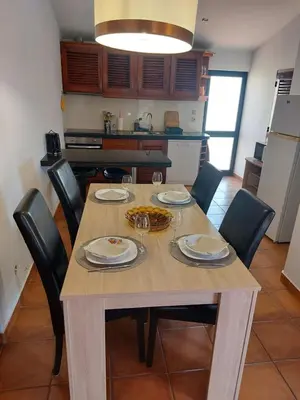 a dining room table with chairs and a dining room table at Jacaranda 43-Moradia terrea in Albufeira