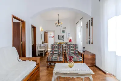 a living room with a bed and a table at #341 Casa da Guida 44 by Home Holidays in Olhos de Água
