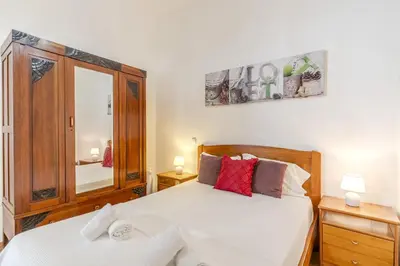 a bedroom with a bed and a mirror at #341 Casa da Guida 44 by Home Holidays in Olhos de Água