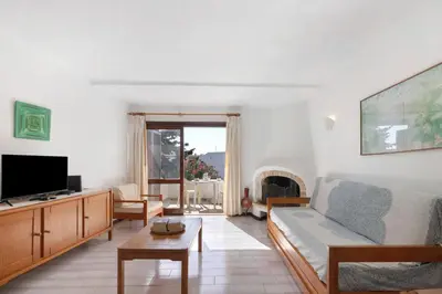 a living room with a couch and a tv at Casa dos Bisos in Albufeira