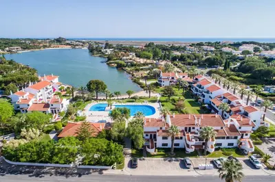 an aerial view of a resort with a body of water at Apartamento Mariana, Quinta do Lago