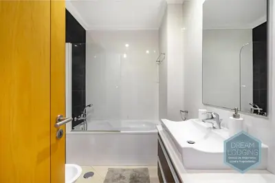 a bathroom with a white tub and a sink at Quinta do Pinheiro Residence AF - Dream Lodging in Albufeira