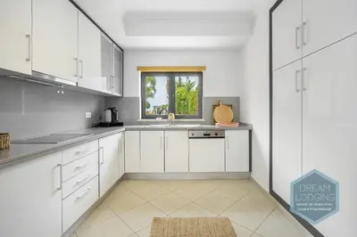 a white kitchen with a sink and a window at Quinta do Pinheiro Residence AF - Dream Lodging in Albufeira