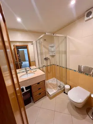 a bathroom with a shower and a toilet and a sink at Vilamoura apartment in Quarteira