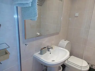 a bathroom with a sink and a toilet and a shower at EncostaOasis Townhouse in Estibeira