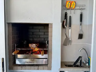 a kitchen with a brick oven with food cooking in it at Gabbiana apartment Albufeira terrace BBQ and pool in Albufeira