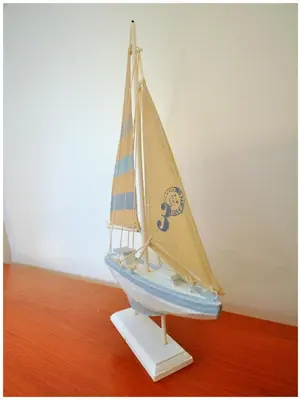a wooden toy sailboat on a wooden floor at Apartamentos Capitolina in Quarteira