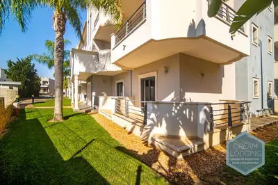 a house with a palm tree in front of it at Pinheiro Residence - Dream Lodging in Albufeira