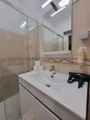 a bathroom with a shower and a toilet and a sink at Happy House - Central Apartment in Faro