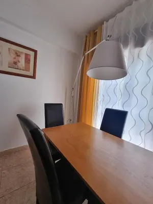 a dining room table with chairs and a lamp at Happy House - Central Apartment in Faro