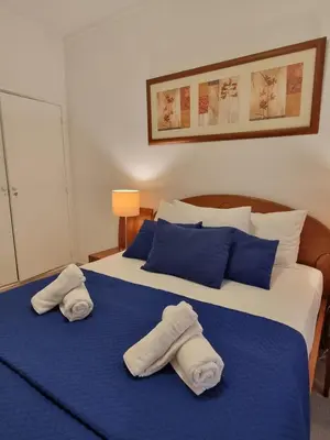 a bedroom with two towels on a bed at Happy House - Central Apartment in Faro
