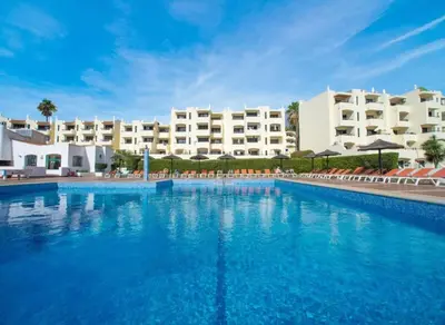 a large swimming pool in front of a hotel at Sea view studio, terrace & pools - Albufeira in Albufeira