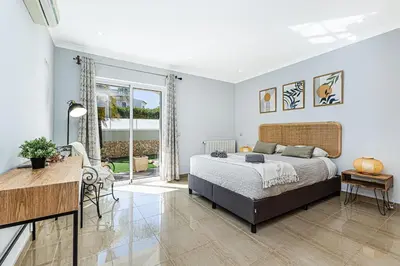 a bedroom with a bed and a desk in it at Quiet Villa Near The Beach, Opcional Heated Pool in Albufeira