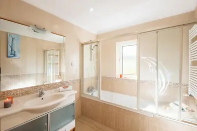 a bathroom with a sink and a shower and a mirror at Quiet Villa Near The Beach, Opcional Heated Pool in Albufeira
