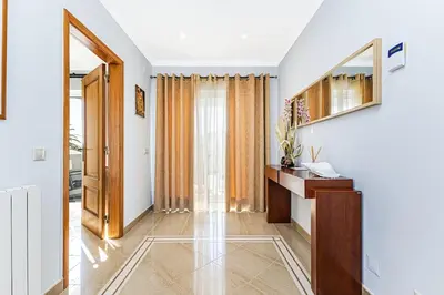 a hallway with a sink and a mirror at Quiet Villa Near The Beach, Opcional Heated Pool in Albufeira