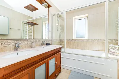 a bathroom with a tub and a sink and a shower at Quiet Villa Near The Beach, Opcional Heated Pool in Albufeira